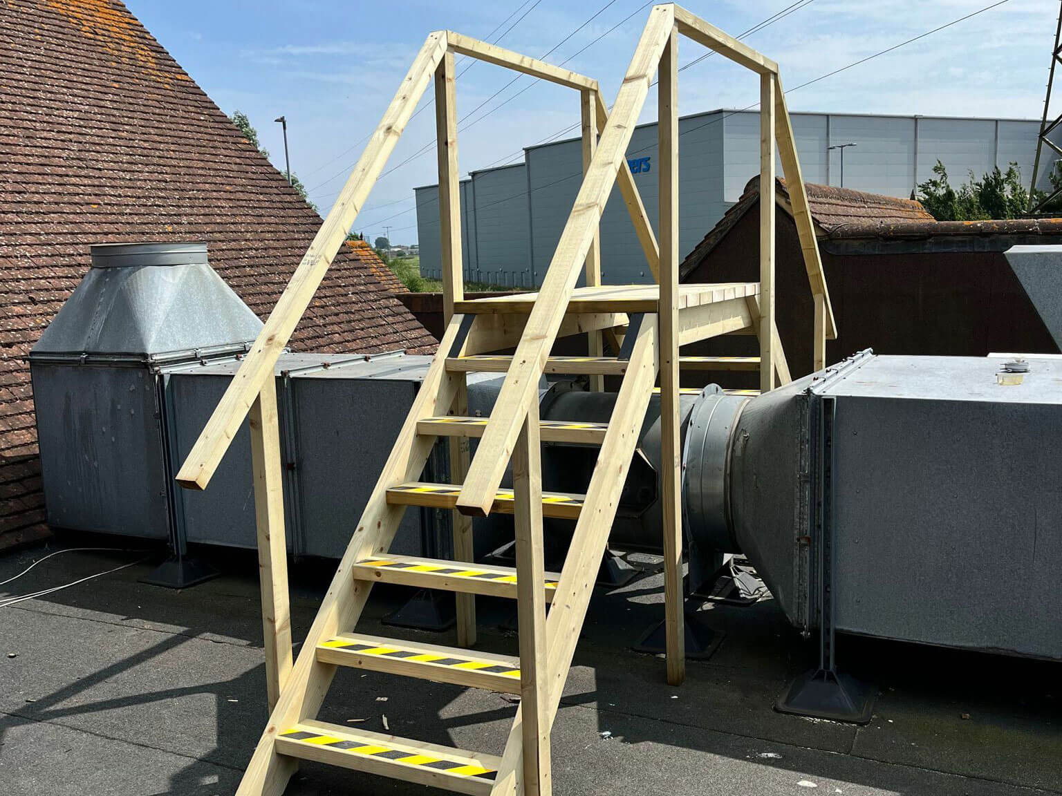 An image showing a wooden staircase on the roof of the Toby Carvery by builders in Eastbourne